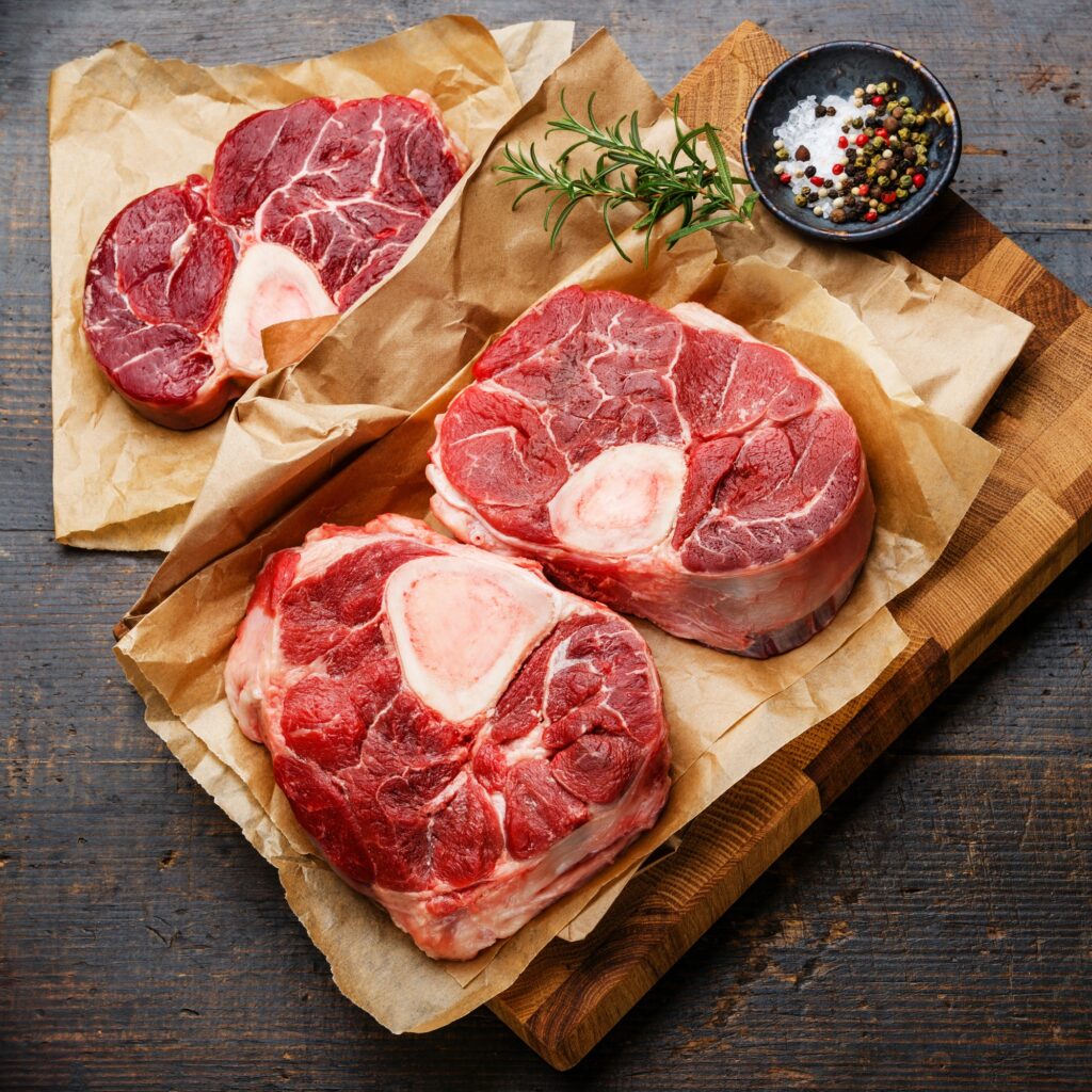 Sliced venison meat on a plate with fresh herbs